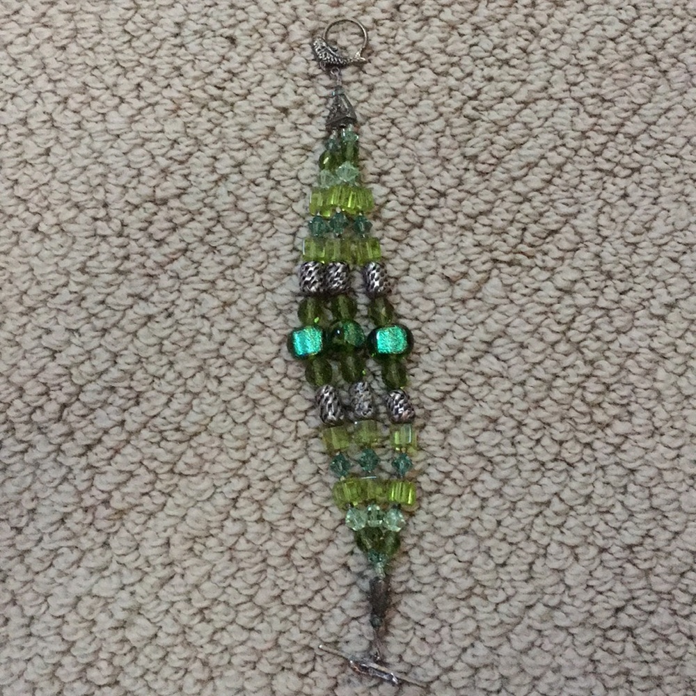 A green three string bracelet